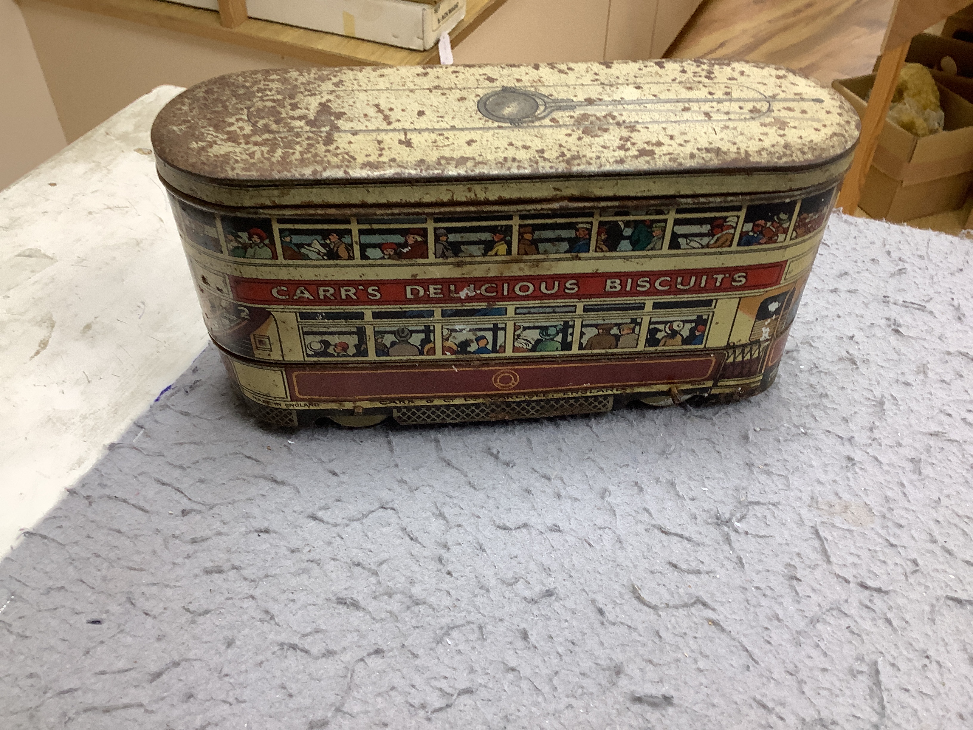 Three tinplate/cast iron toys; a Jaeger cast iron concrete mixer, a Carr’s tinplate biscuit tin in the form of a tram, and a clockwork teddy bear on a tricycle, tram 22cm long